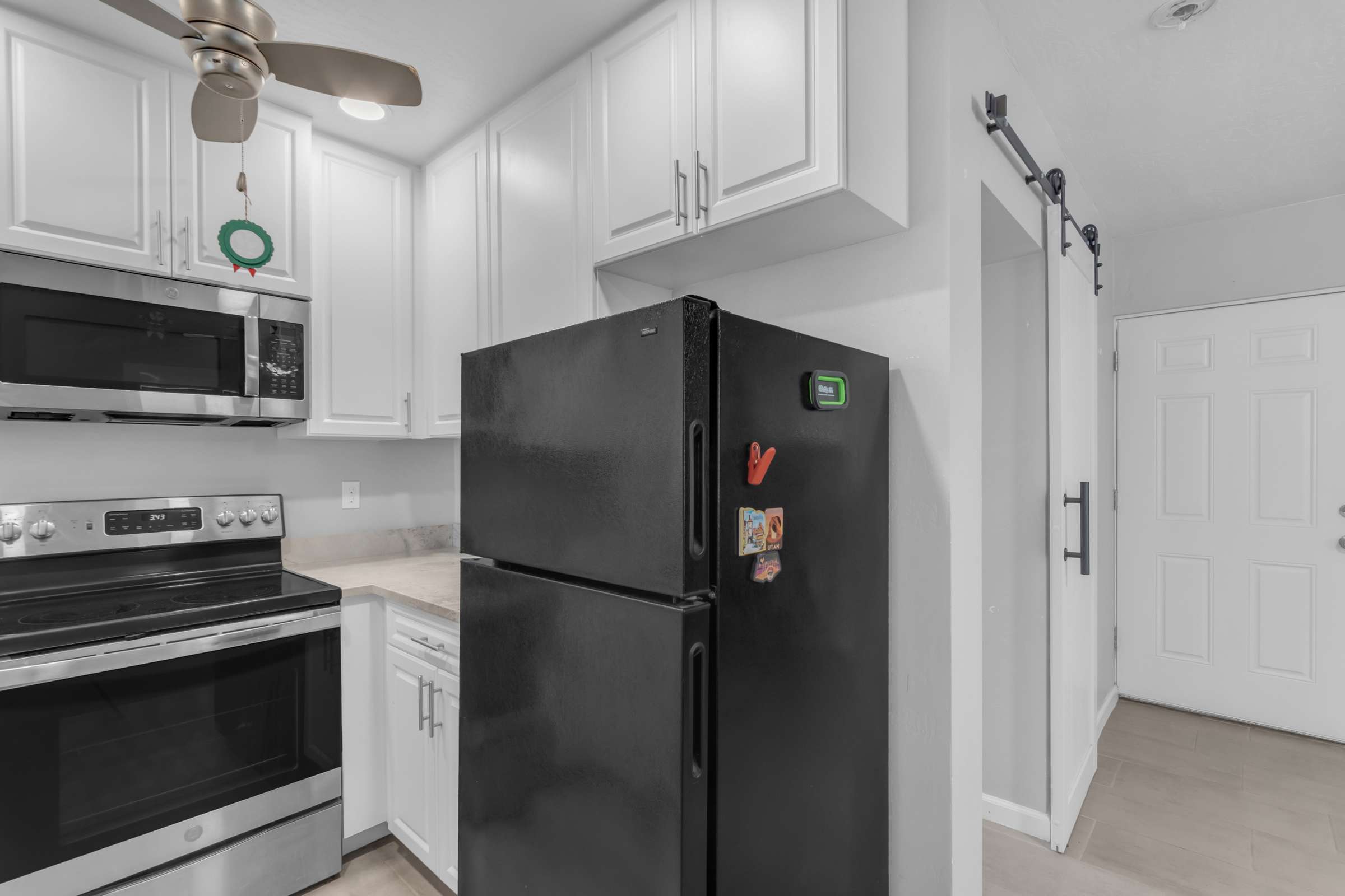 15 of 43. Bright kitchen space offers quality cabinetry, modern appliances, generous counter space, and easy access to the adjoining living area, delivering comfort and convenience.