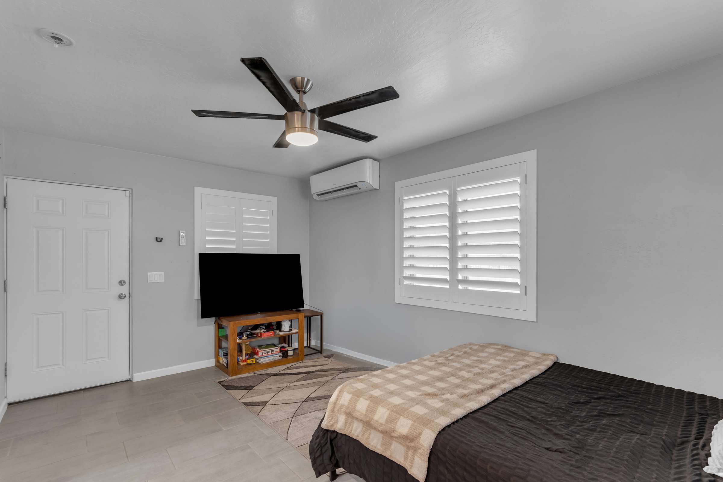 16 of 43. Bright guest suite features updated finishes, plantation shutters, mini-split cooling, and flexible living space ideal for visitors, extended family, or private accommodations.