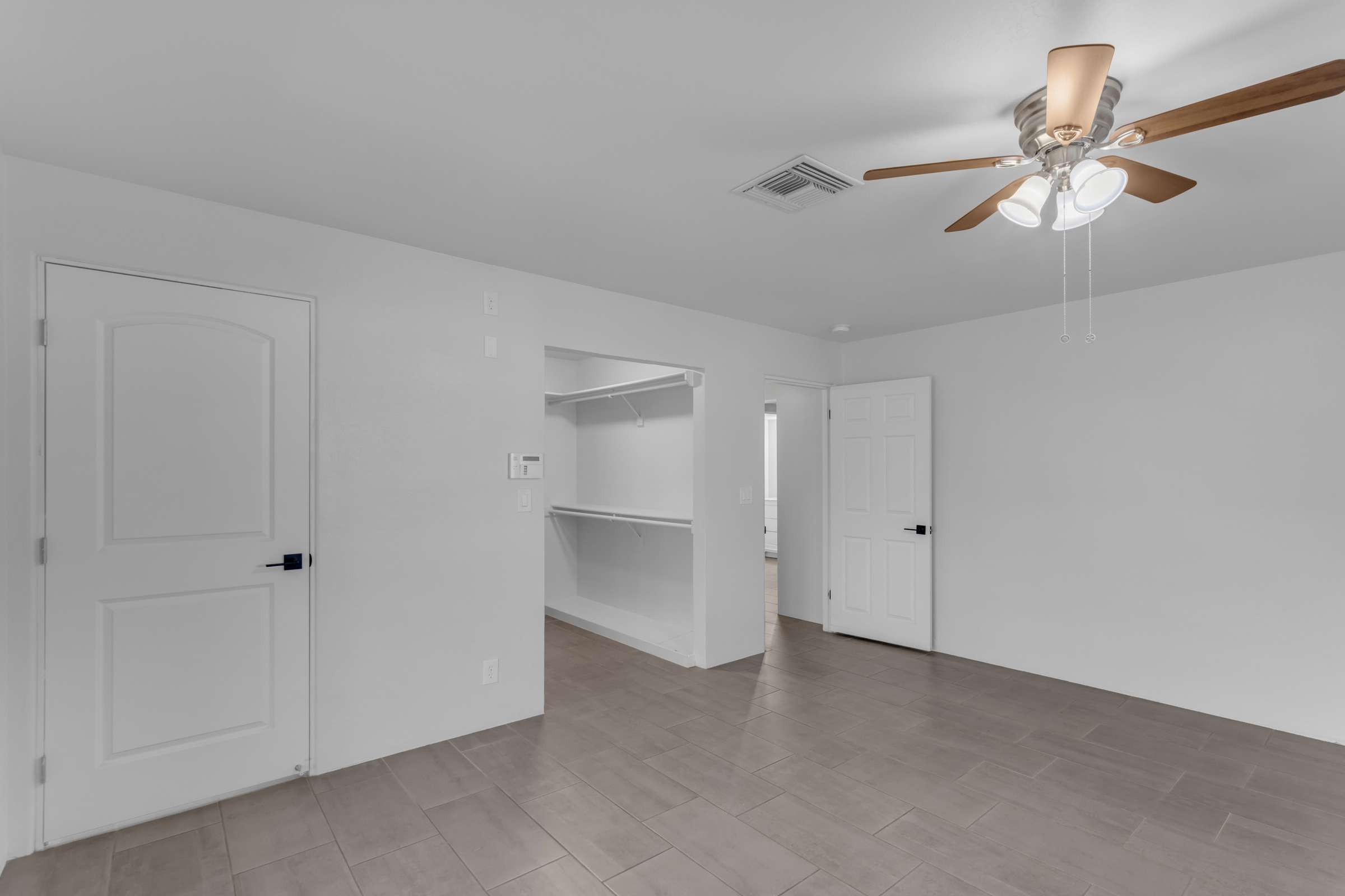 23 of 43. Comfortable primary suite offers updated flooring, ceiling fan, neutral finishes, and convenient access to the walk-in closet and remodeled ensuite bathroom for everyday comfort.