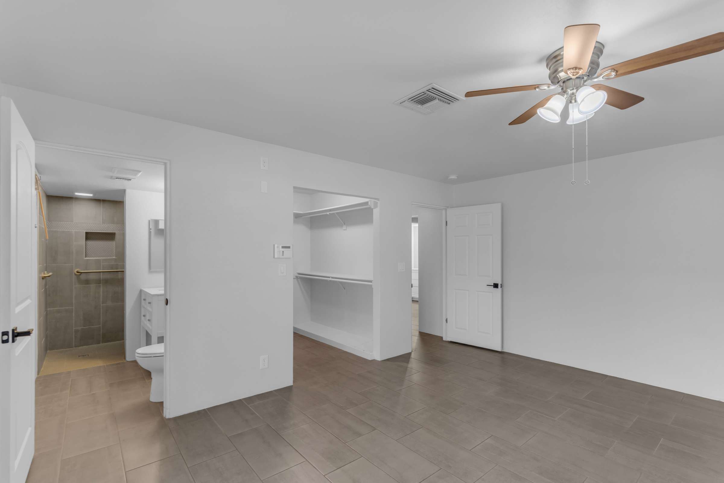 24 of 43. Renovated ensuite bathroom features a modern vanity, updated lighting, quartz-style countertop, and spacious walk-in tiled shower, delivering a clean and contemporary design.