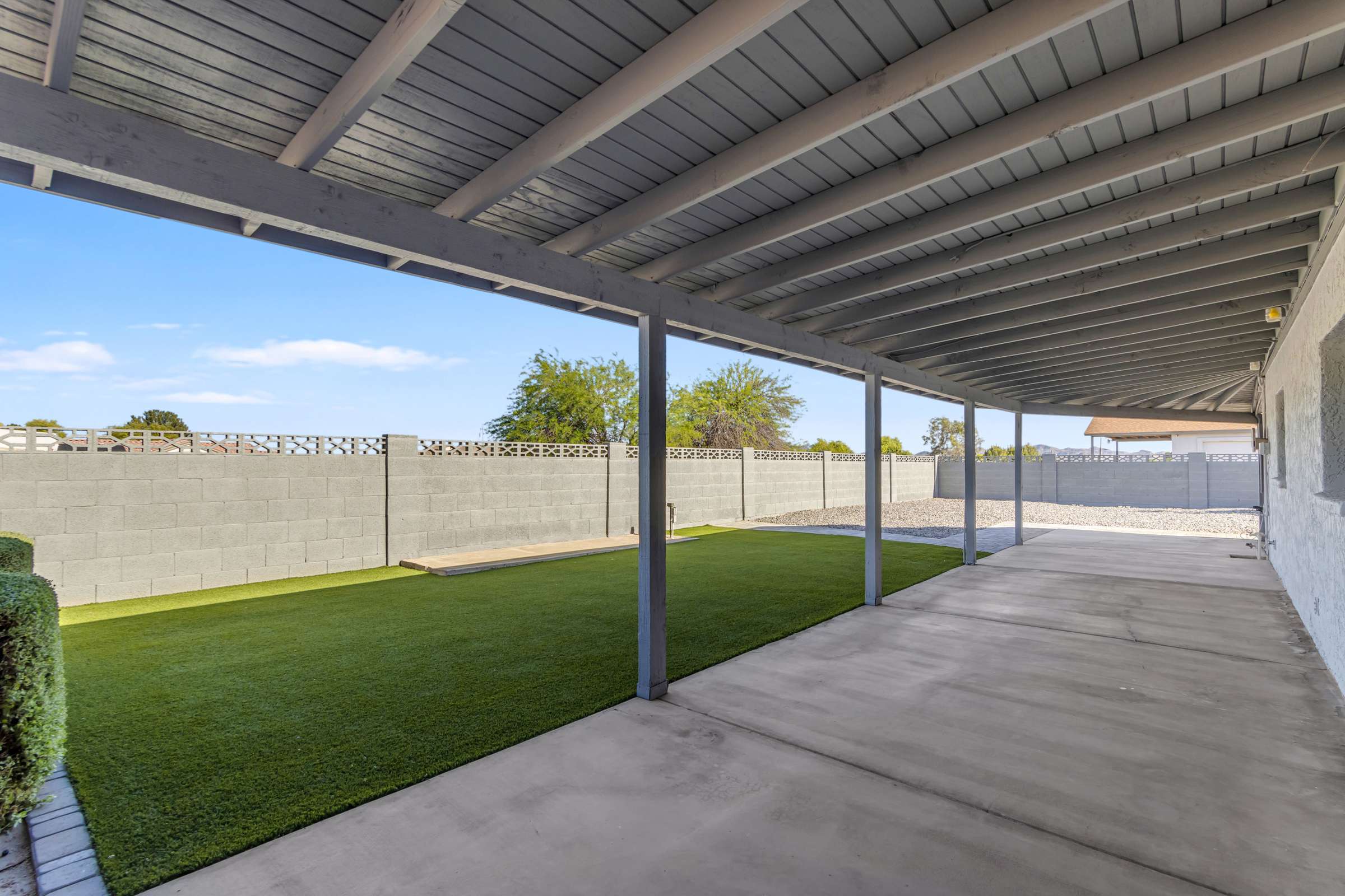 34 of 43. Oversized covered patio offers generous shaded seating with views of the landscaped backyard, making it ideal for outdoor dining, gatherings, and relaxing throughout the year.
