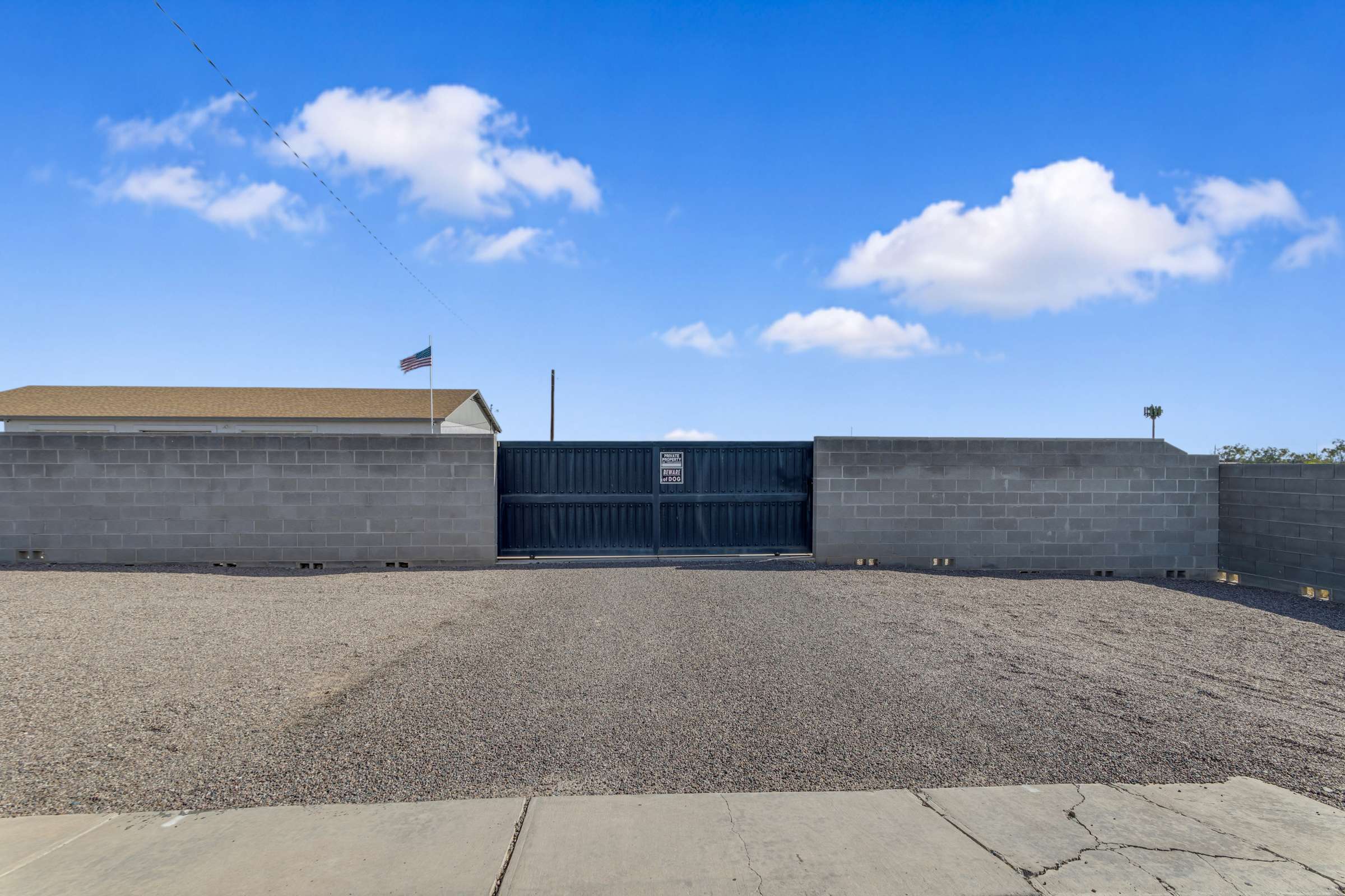42 of 43. Secure metal gate and block wall fencing create a private entrance with convenient access for oversized vehicles, recreational equipment, and extra parking flexibility.