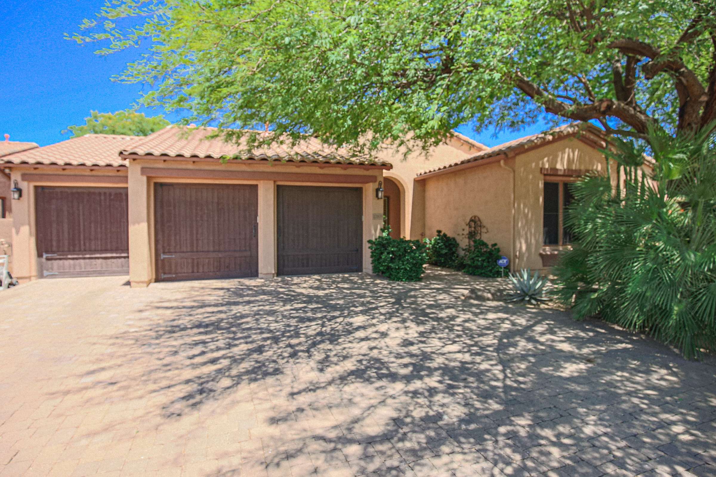 2 of 72. Arrive home to impressive curb appeal with a paver driveway, mature landscaping, and an oversized garage. This elegant residence is situated within a desirable gated Scottsdale neighborhood.