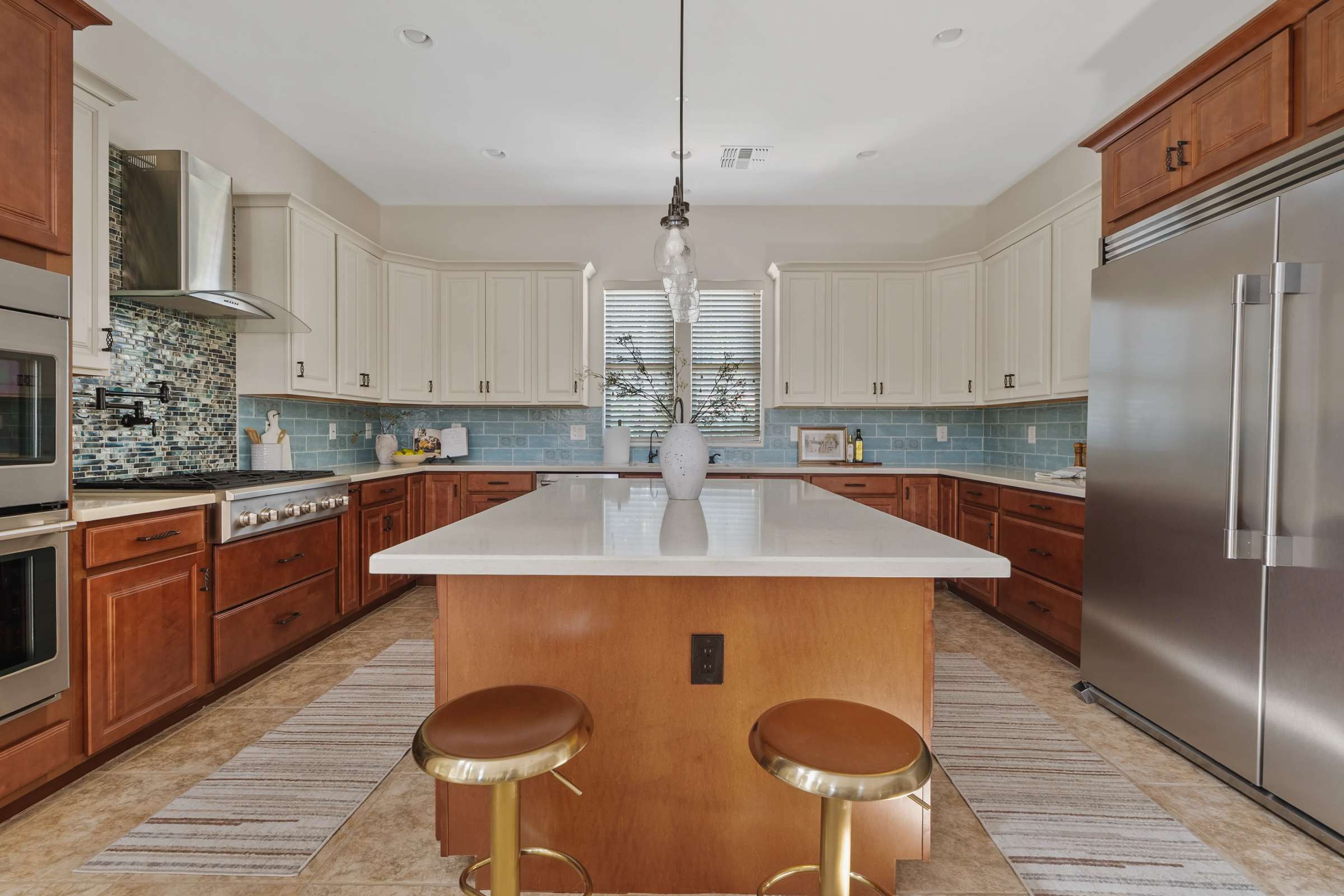 3 of 72. Featuring quartz countertops, premium stainless steel appliances, extensive cabinetry, double ovens, and a large center island, this gourmet kitchen is perfectly equipped for cooking and entertaining.