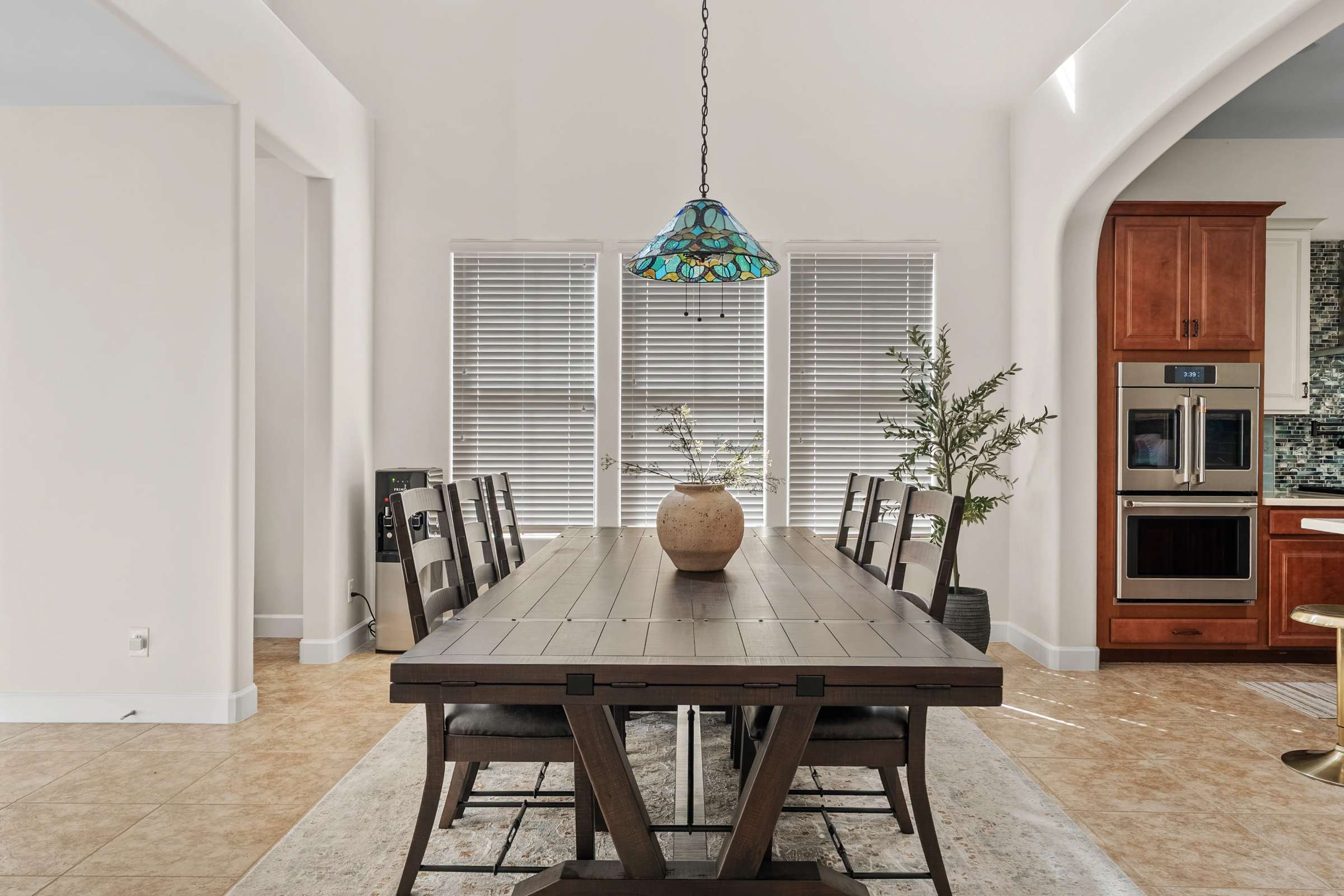 5 of 72. Filled with natural light, this inviting breakfast area offers the perfect place for everyday meals while overlooking the beautifully designed interior spaces of this Scottsdale home.