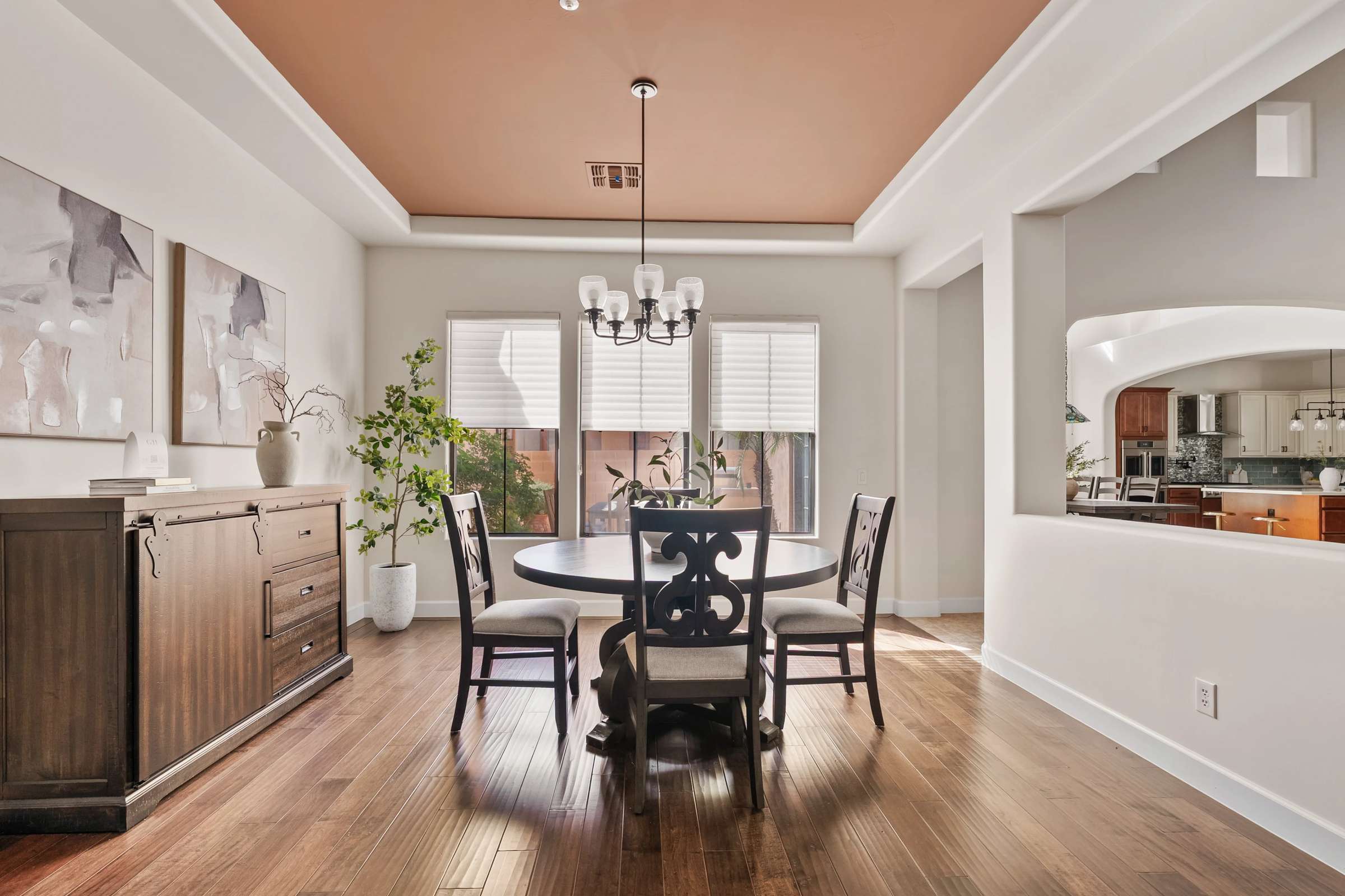 9 of 72. Designed for entertaining, this formal dining room features rich wood flooring, tray ceilings, abundant natural light, and seamless access to the gourmet kitchen and living areas.