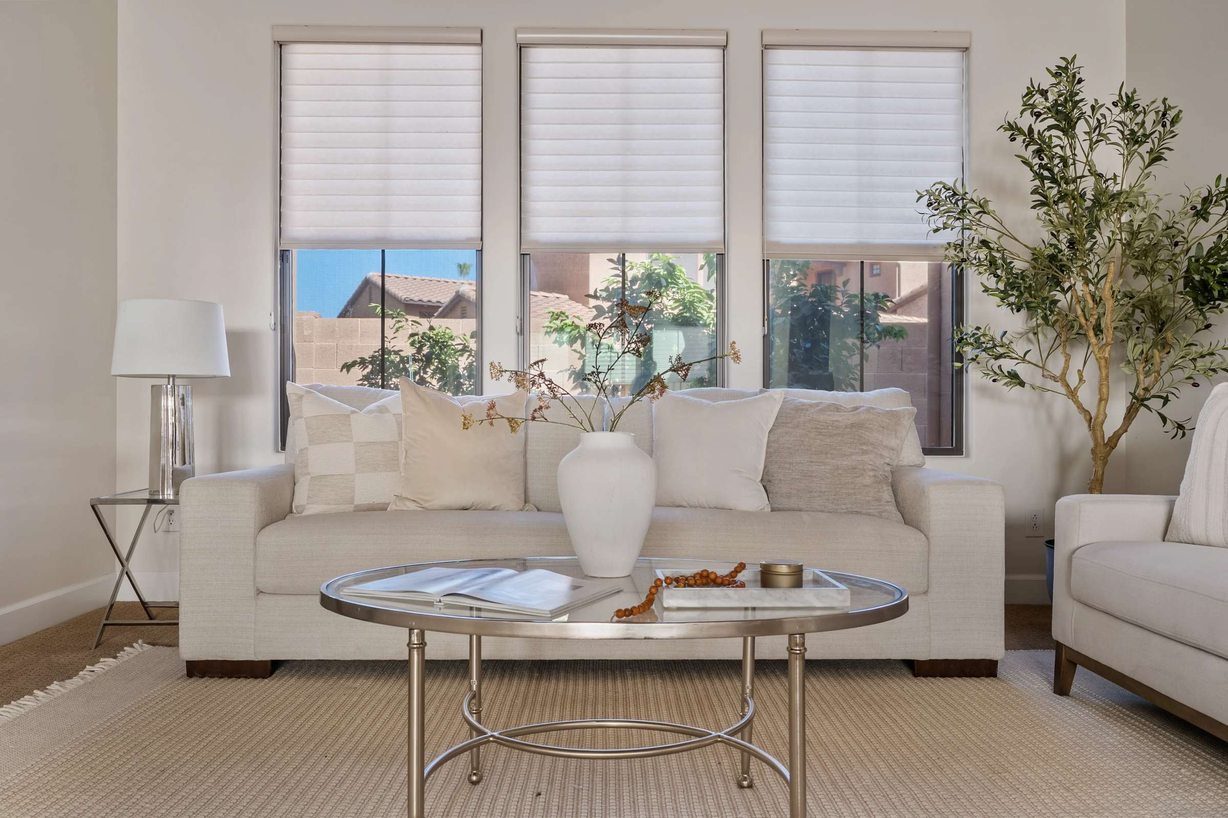 10 of 72. Large windows, elegant finishes, and a spacious layout make this formal living room an inviting space for entertaining or relaxing while enjoying the comfort and luxury of this Scottsdale residence.