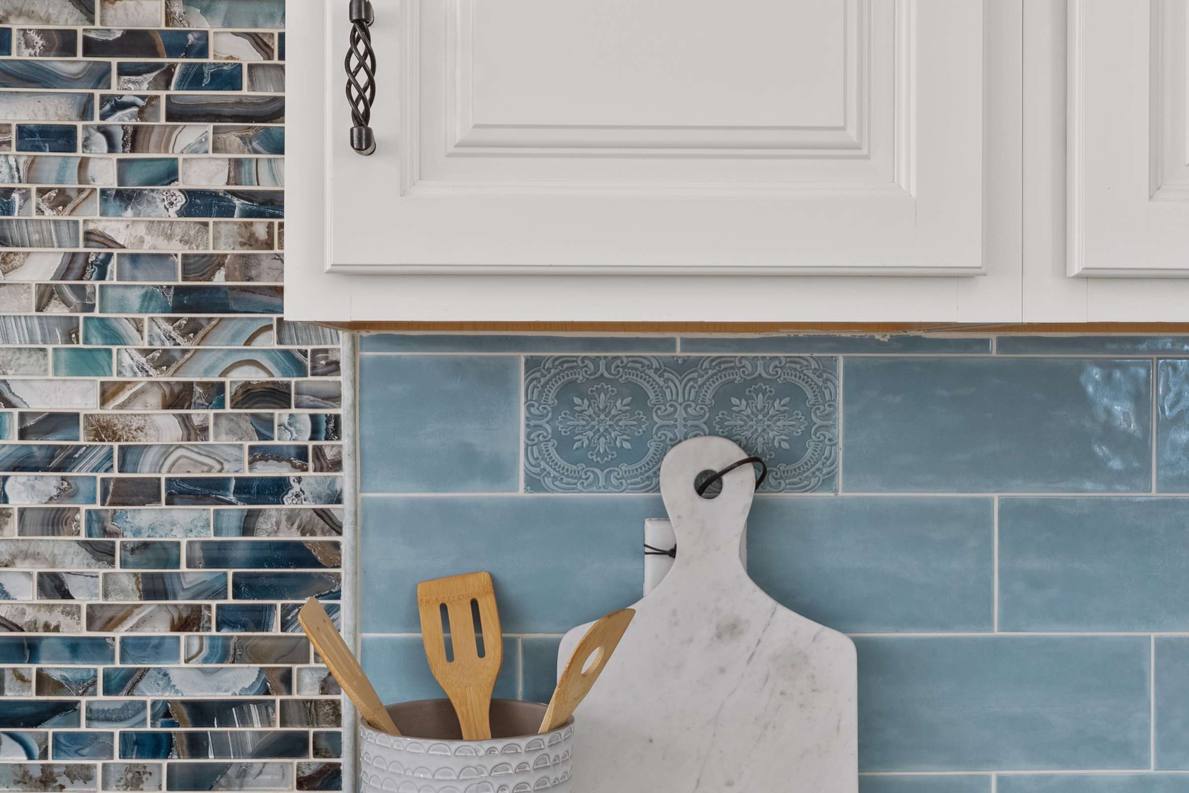 20 of 72. Decorative tile backsplash, quartz countertops, custom cabinetry, and quality finishes showcase the craftsmanship found throughout this beautifully updated Scottsdale kitchen.