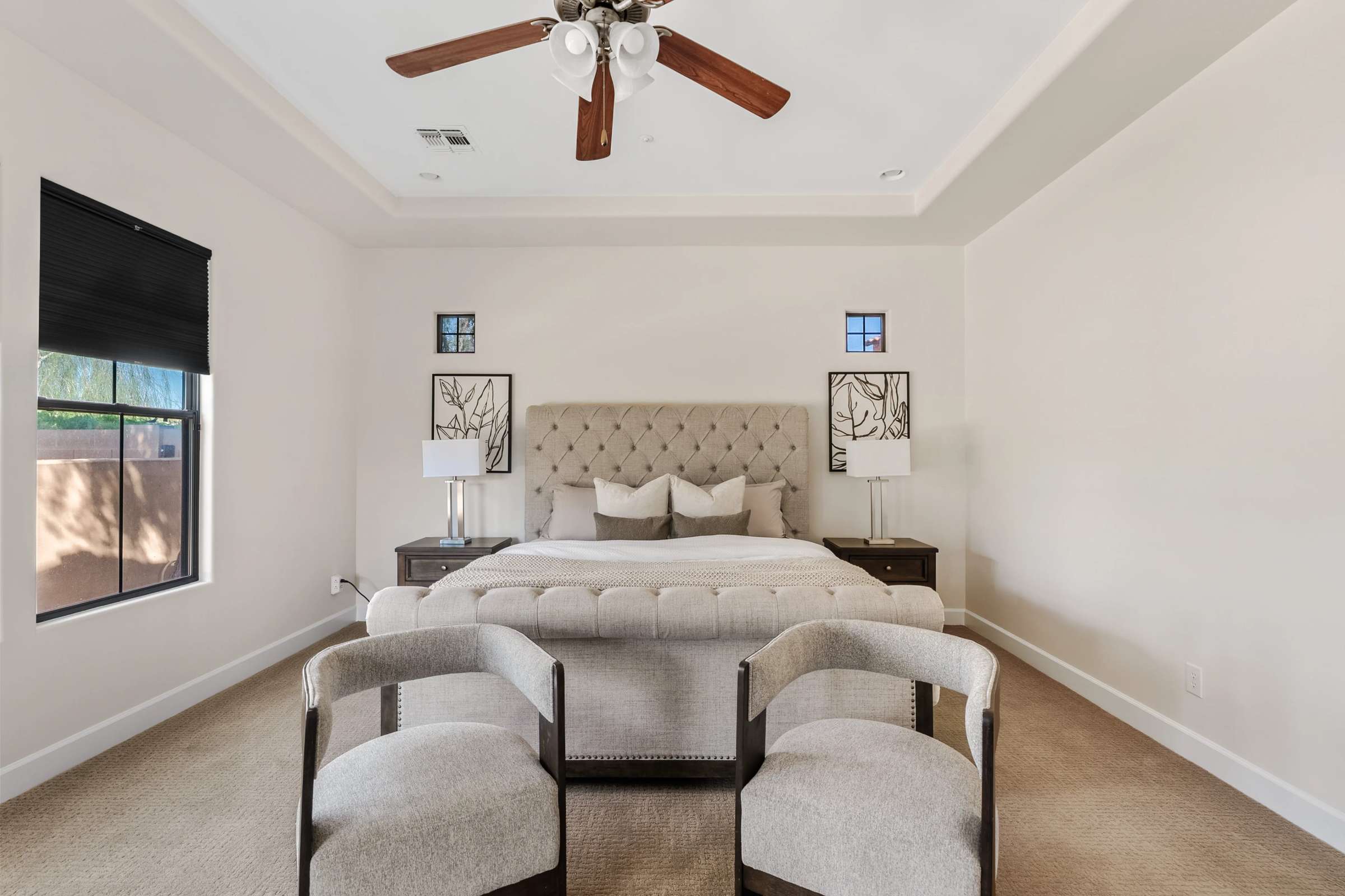 28 of 72. This luxurious owner's suite offers a spacious layout, tray ceiling, plush carpeting, and abundant room for a seating area, creating a relaxing private retreat.