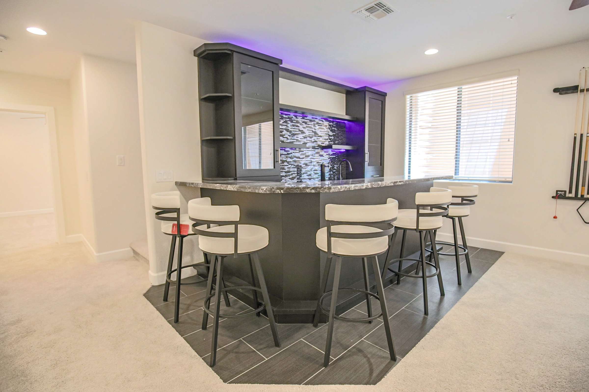 45 of 72. Premium granite surfaces, custom cabinetry, built-in storage, beverage sink, and stylish finishes make this wet bar the centerpiece of the home's entertainment level.