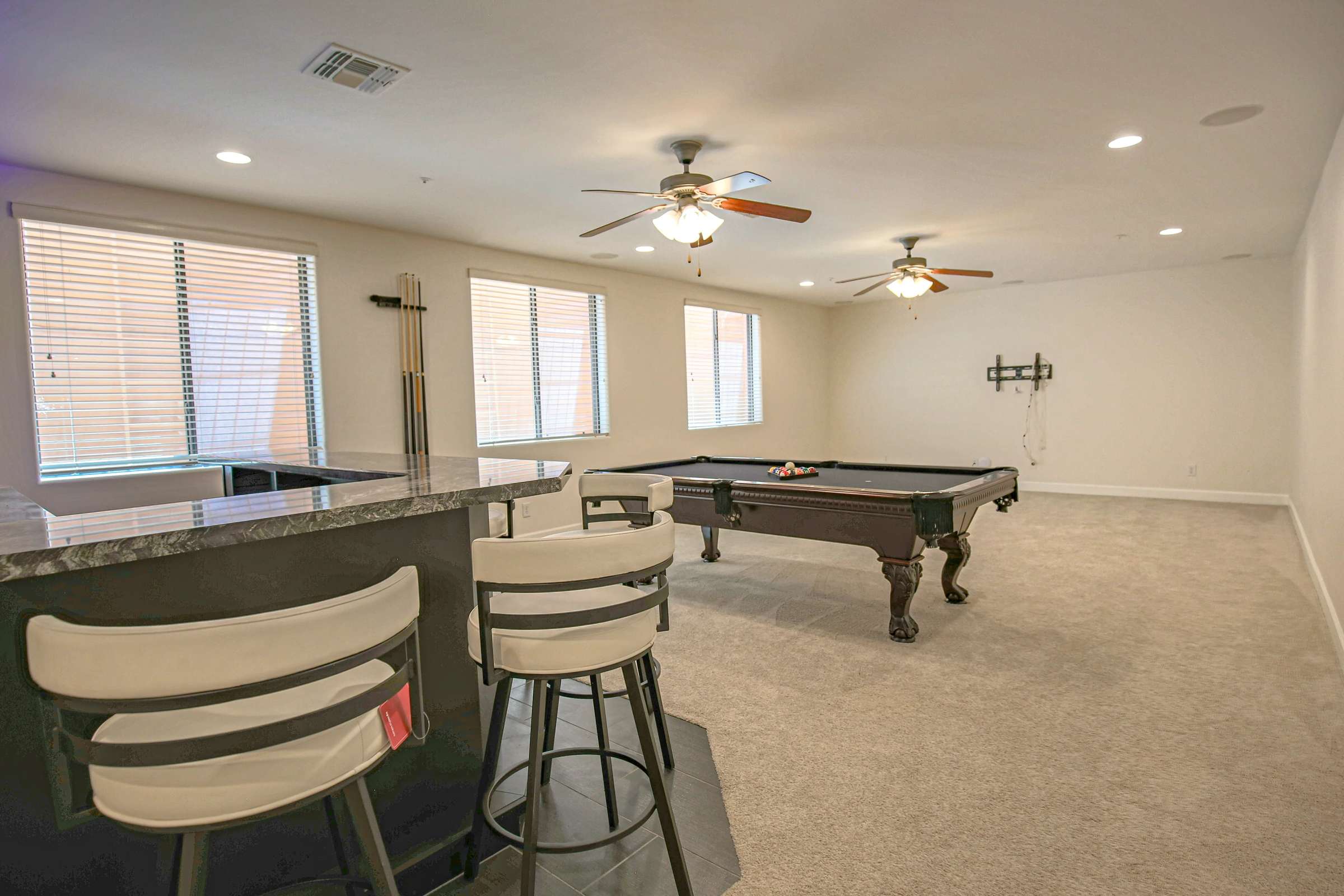 46 of 72. The spacious finished basement provides ample room for billiards, movie nights, gatherings, and flexible recreation while offering easy access to the adjacent custom wet bar.