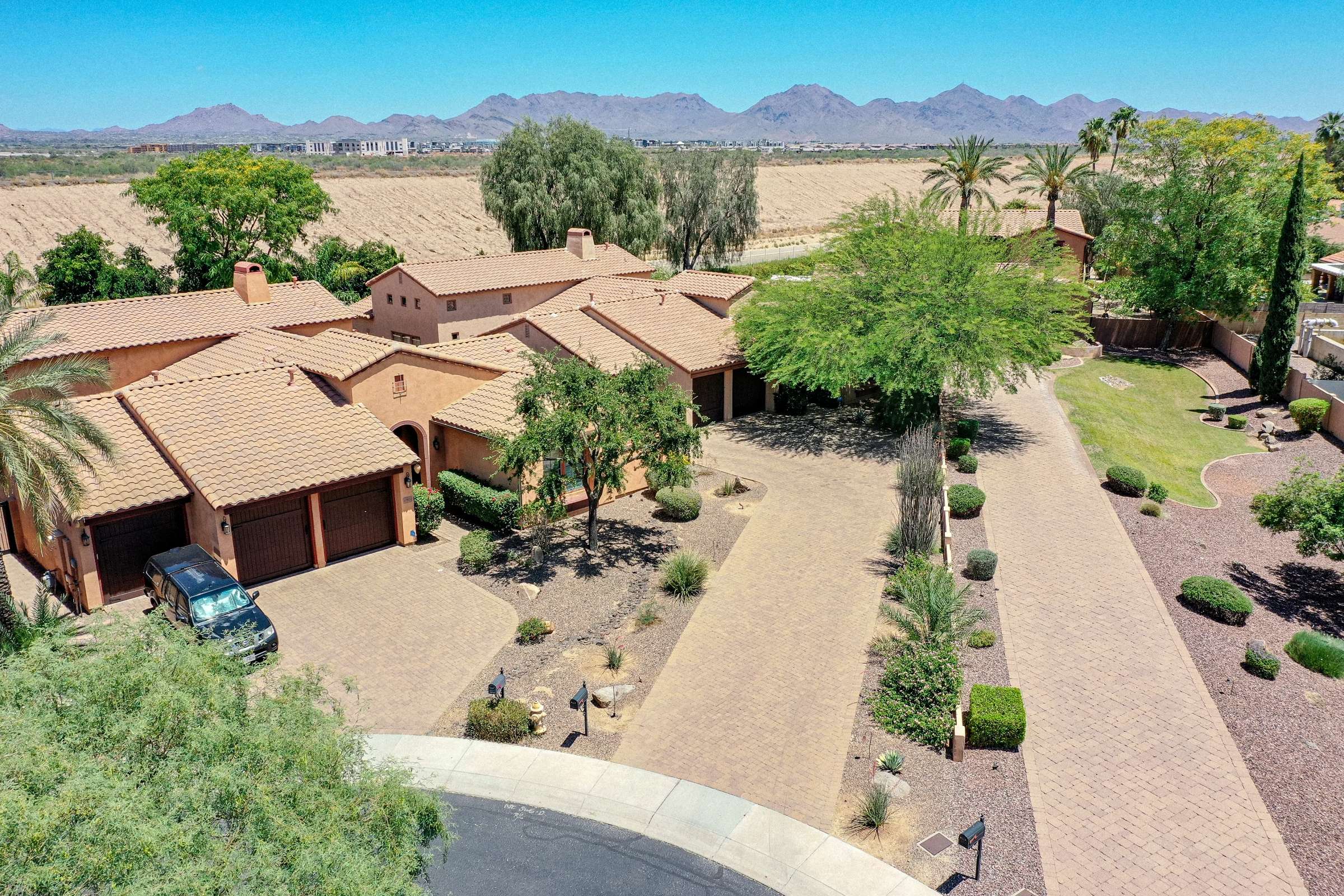 69 of 72. An impressive aerial view captures the home's generous lot, mature landscaping, neighboring properties, mountain backdrop, and desirable Scottsdale setting.