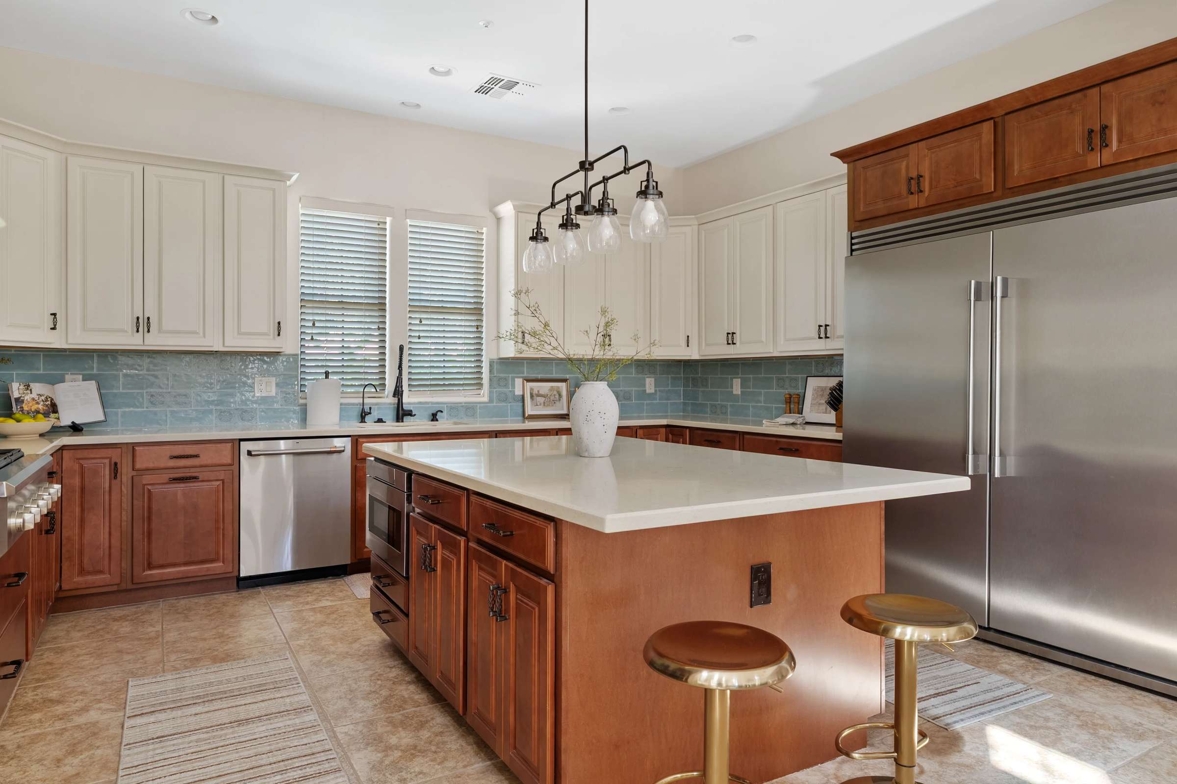 24 of 72. An open view of the gourmet kitchen highlights the oversized island, stainless steel appliances, quartz countertops, custom cabinetry, designer lighting, and spacious layout perfect for gatherings.