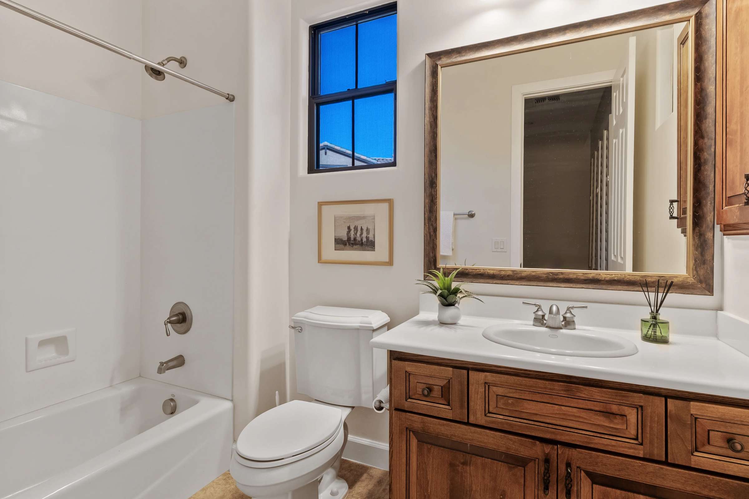 25 of 72. Featuring a full tub and shower, generous vanity, and quality finishes, this secondary bathroom offers convenience, comfort, and natural light for family members and guests.