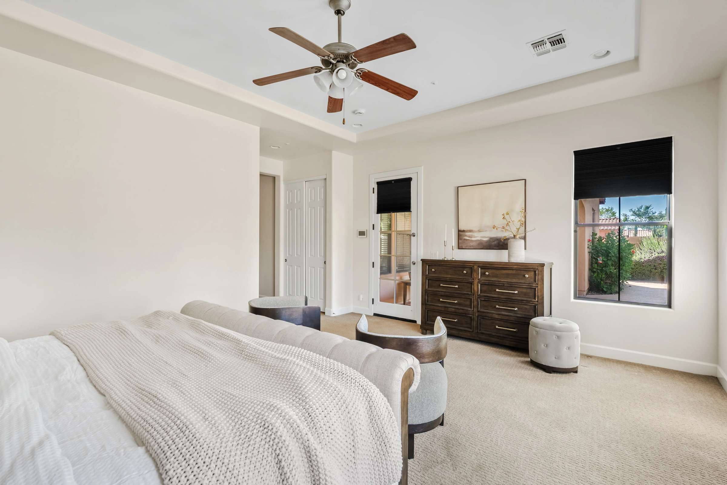 29 of 72. A second perspective highlights the spacious owner's suite with private patio access, tray ceiling, oversized proportions, and comfortable living space designed for relaxation.