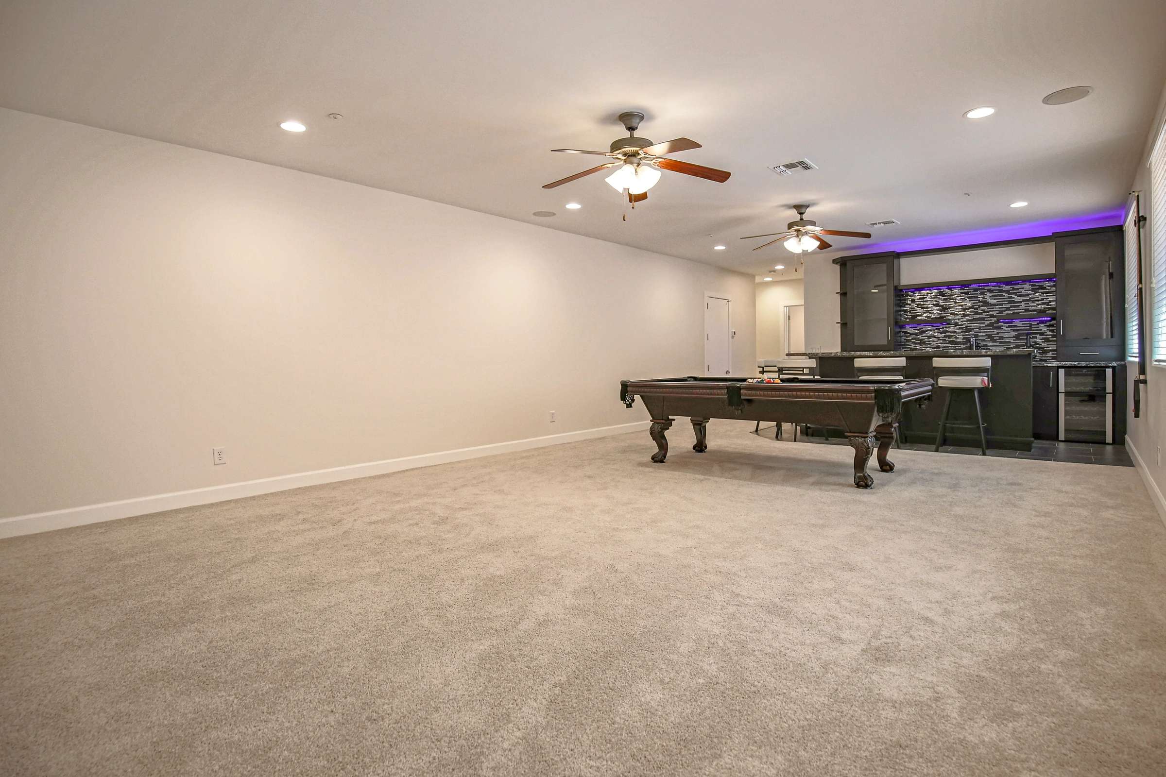 48 of 72. This versatile finished basement offers generous open living space ideal for a home theater, fitness area, game room, or additional family room with premium finishes throughout.