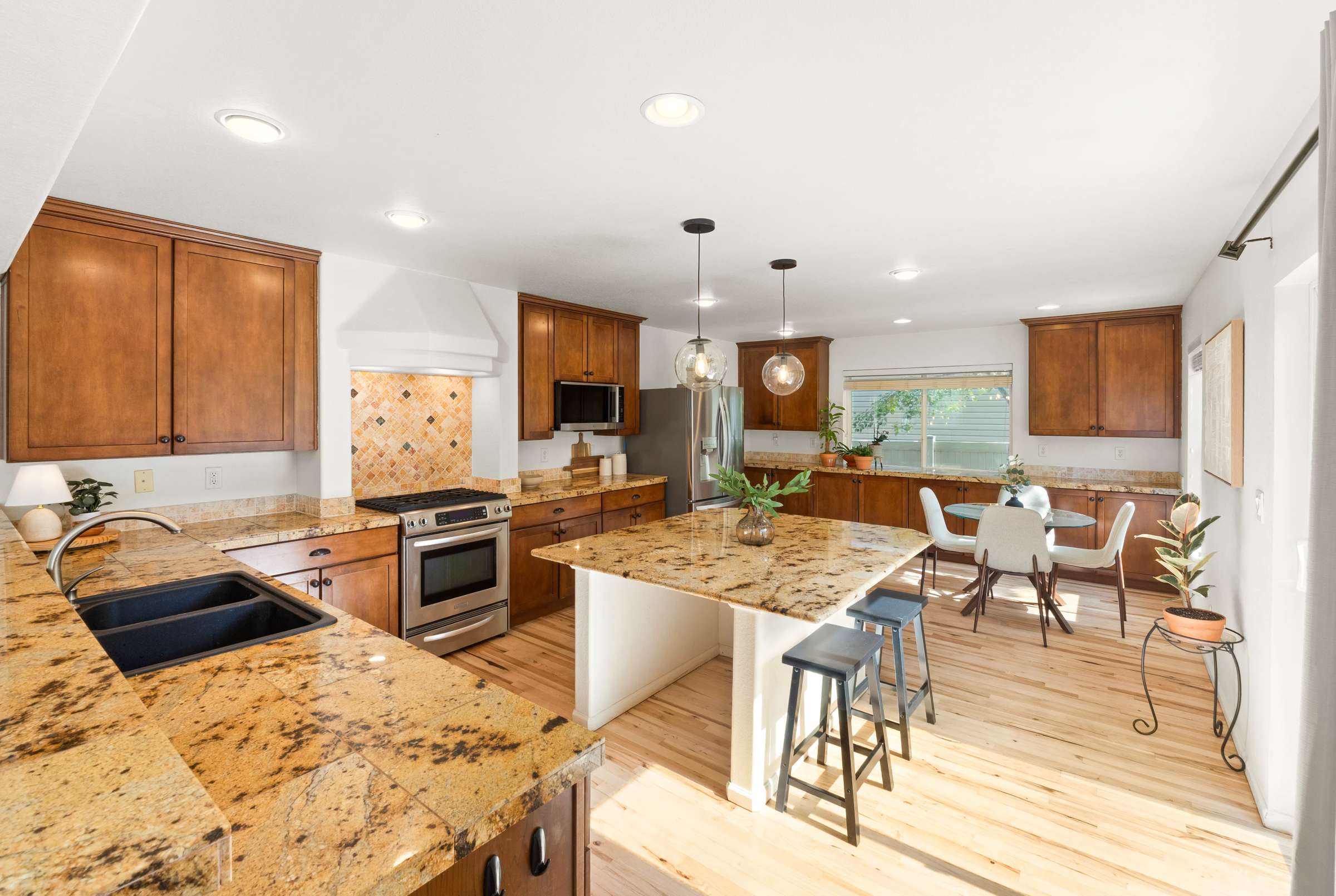 13 of 51. Discover a spacious kitchen with granite island, an abundance of cabinets, and natural light.