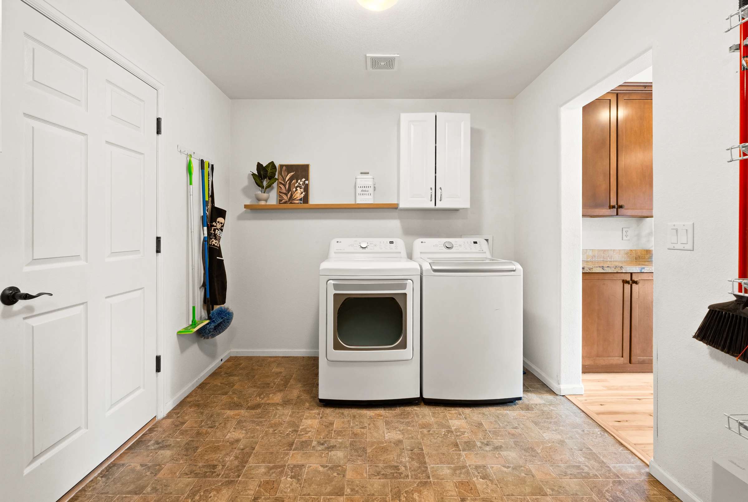 21 of 51. A laundry space is located directly off the kitchen.