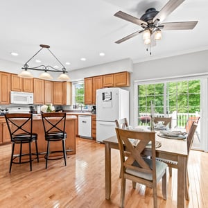 Bright and spacious kitchen featuring ample cabinetry, modern appliances, and a welcoming dining area with outdoor views.