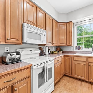 Bright and functional kitchen featuring ample cabinetry, modern appliances, and a view of the outdoors.