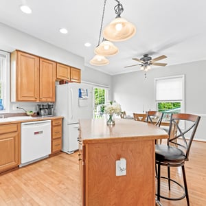 Bright and inviting kitchen featuring ample cabinetry, modern appliances, and a spacious island for casual dining.