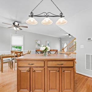This bright and inviting kitchen features a spacious island and opens to a lovely dining area.