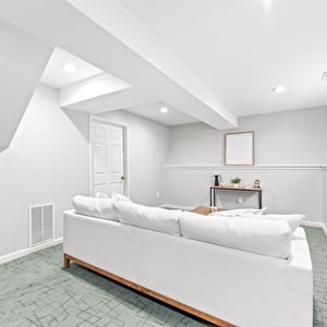 Spacious basement retreat featuring versatile living space and natural light, perfect for relaxation or entertainment.