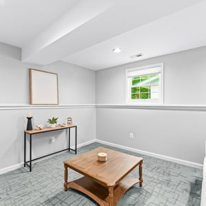 Bright and inviting basement space, perfect for relaxation or a home office, featuring ample natural light.