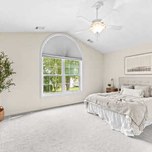 Spacious primary bedroom featuring high ceilings, ample natural light, and incredible water views.
