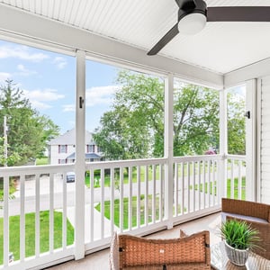 Bright and inviting screened porch with a refreshing water view, perfect for relaxation or entertaining.