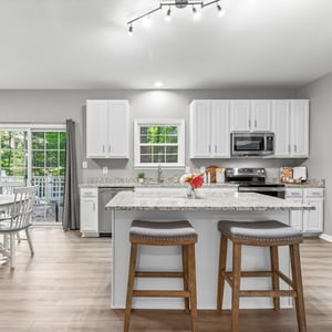 Bright and inviting kitchen featuring modern appliances, ample counter space, and easy access to outdoor living.