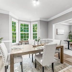 Inviting dining area with ample natural light, featuring large windows and an open flow to adjacent spaces.