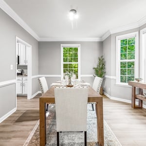 Bright and inviting dining area featuring large windows, modern decor, and a spacious layout perfect for gatherings.