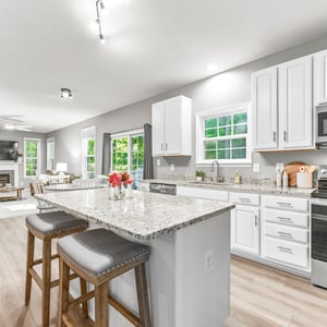 Bright and spacious kitchen featuring modern appliances, ample counter space, and a seamless flow into the living area.