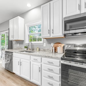 Modern kitchen featuring sleek appliances, ample counter space, and natural light streaming through the windows.