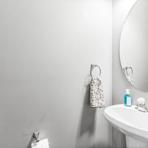 This modern main-floor bathroom features clean lines, functional fixtures, and is perfect for daily convenience.