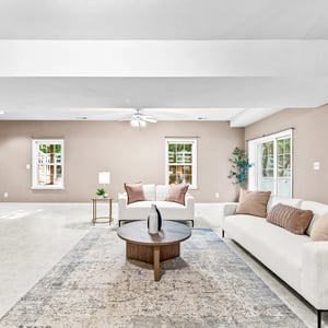 Spacious living area features large windows and flexible layout, perfect for entertaining or relaxing.