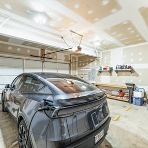 Spacious 2 car garage featuring ample storage space and room for your electric vehicle with an EV charger hookup, and plenty of space for additional projects.