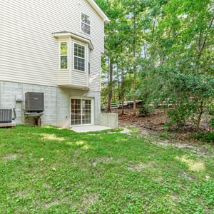 Spacious backyard with walkout basement access, perfect for outdoor gatherings and privacy.