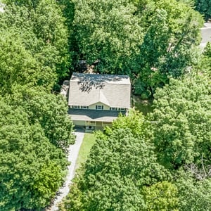 Nestled among lush trees, this spacious home offers privacy and tranquility in a desirable neighborhood.