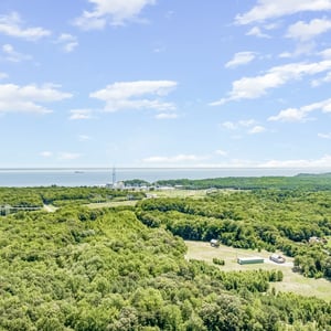 Sprawling wooded landscape with stunning waterfront views, ideal for this beautiful home retreat.