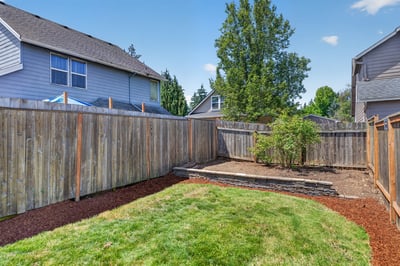 This private backyard features a spacious patio area, perfect for outdoor gatherings and relaxing.