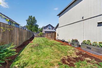 Spacious backyard featuring well-maintained landscaping and ample room for outdoor activities or gardening.