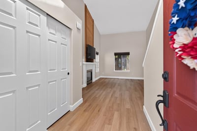 Bright entryway featuring spacious layout, modern fireplace, and large windows for ample natural light.