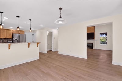 Bright, open living area seamlessly connects to a modern kitchen, perfect for entertaining and comfortable living.