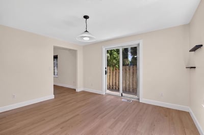Bright and open living space with ample natural light and direct access to a private outdoor area.