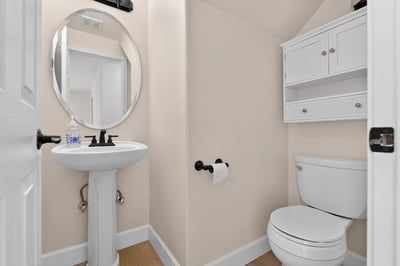 Bright and functional half-bath features updated fixtures and efficient use of space for everyday convenience.