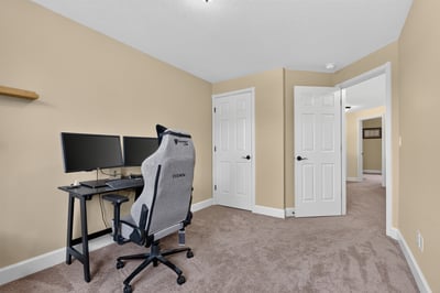 Bright and airy room, perfect for a home office or study area, featuring dual workstations.