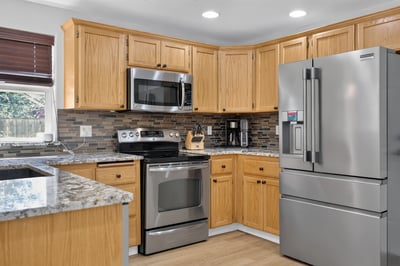 Modern kitchen featuring sleek stainless steel appliances and abundant counter space, ideal for cooking and entertaining.