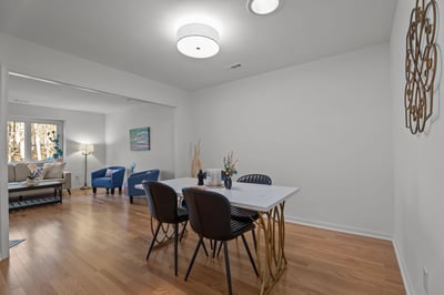 Dining room with new light fixture and hardwood floors